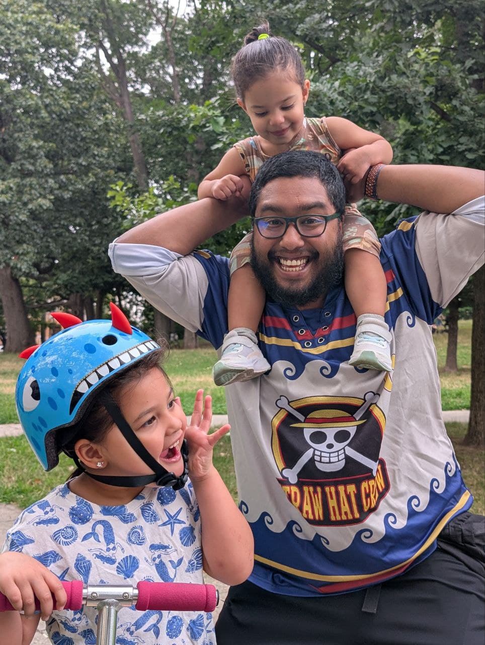 Rizbe with his two children at the park